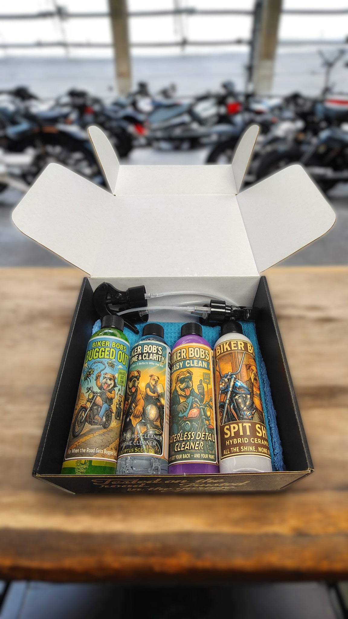 Box of Biker Bob's Detail kit on a wooden surface with motorcycles in the background